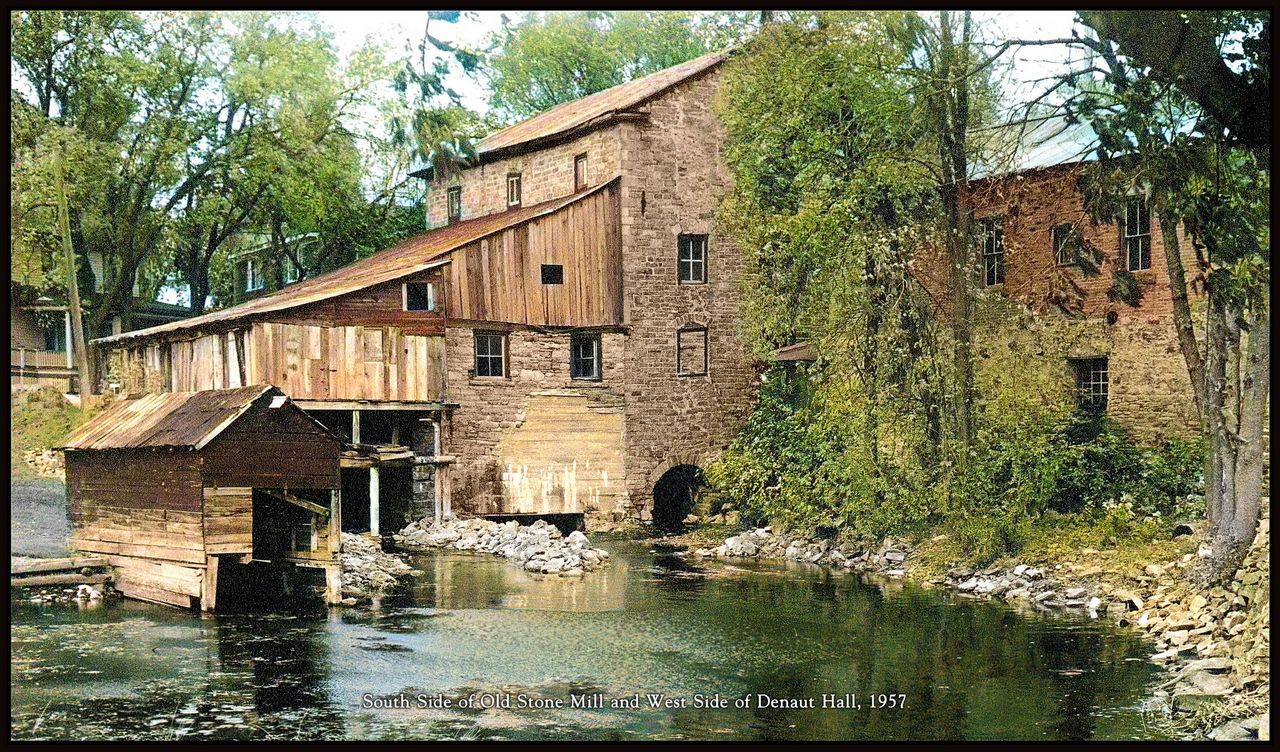 South side of the Old Stone Mill and west side of Denaut Hall, 1957 — wooden structures deteriorating before restoration