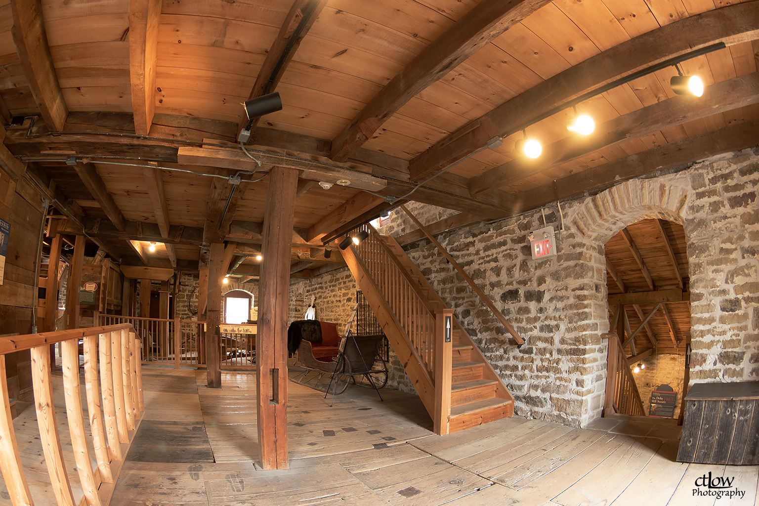 Second floor of the Old Stone Mill today — exposed timber framing above the original limestone walls and stone archway